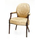 An Hepplewhite-style mahogany elbow chair,upholstered in gold damask, with carved arm supports, on