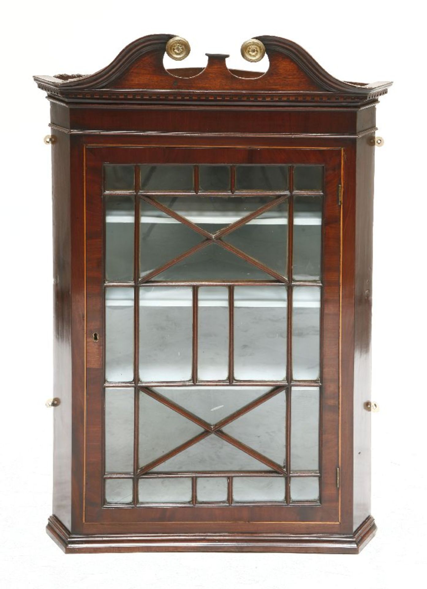 A George III-style mahogany hanging corner cupboard,late 19th century, with a scrolled cornice and