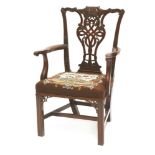 A Chippendale-style mahogany elbow chair,the shaped back with an ornately carved and pieced vase-