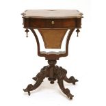 A Victorian rosewood worktable,the serpentine top with a frieze drawer, over a work basket and