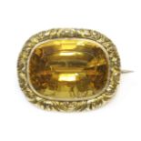 A William IV gold cased single stone citrine brooch, c.1880,a cushion cut citrine, rub set to a