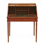 An Edwardian satinwood bureau de dame,with a tambour enclosing a fitted interior, over two frieze