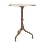 A mahogany tripod table,19th century, the oval top and turned column on downswept legs,57cm wide74cm
