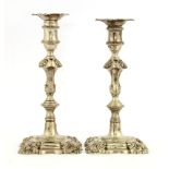 A pair of George III cast silver candlesticks,by ...'JH', London 1764, capitals unmarked,with