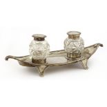 A silver inkstand,by Robert Pringle & Sons, London 1913, of navette shape fitted with two silver-