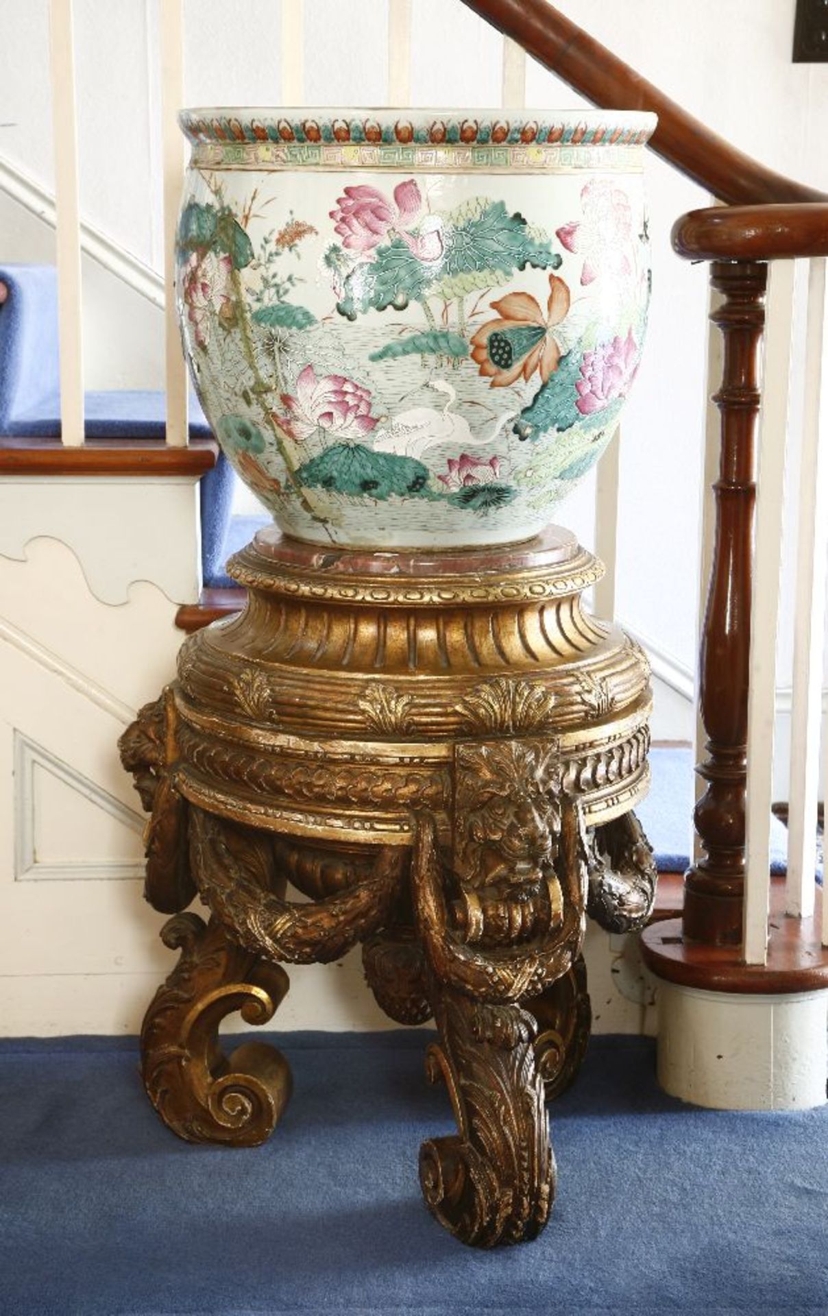 A large Chinese porcelain fish bowl, late 19th century, extensively restored, on a carved giltwood