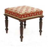 A Victorian mahogany stool, with an embroidered seat on turned tapering reeded legs,49cm