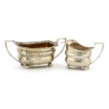 A George III silver two-handled sugar bowl and milk jug,by J W Story & W Elliot, London 1812, of