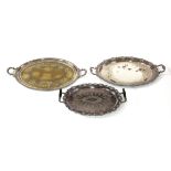 Three Victorian large oval silver-plated trays,each with a cast border,56, 73 and 77cm long (3)