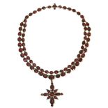 A late 18th century two row garnet set rivière with a garnet set cruciform pendant, the rivière