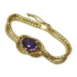 A Victorian amethyst and diamond two row bracelet,an oval mixed cut amethyst, each claw set with a