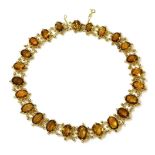 A Victorian gold graduated citrine rivière, with a series of graduated oval cut citrines, each one