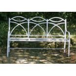 A Regency-style painted iron garden seat,with an arched three-seat back over a slatted seat,55cm