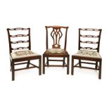 A pair of Chippendale period single chairs,with pierced ladder backs, needlepoint drop-in seats