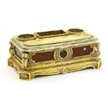 A gilt bronze standish,mid 19th century, with a pen tray, two inkwells and a rectangular recess, the