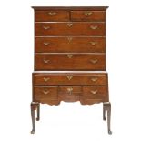 A George III oak chest on stand,the top section with two short and three long drawers, the base with