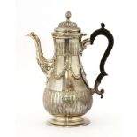 A Victorian silver coffee pot,London 1862,of baluster form embossed with reeded flutes and husk