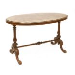 A Victorian inlaid walnut oval centre table,on turned and fluted end supports and outswept legs,