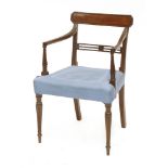 A George III mahogany bar back elbow chair,with reeded downswept arms and supports, on an