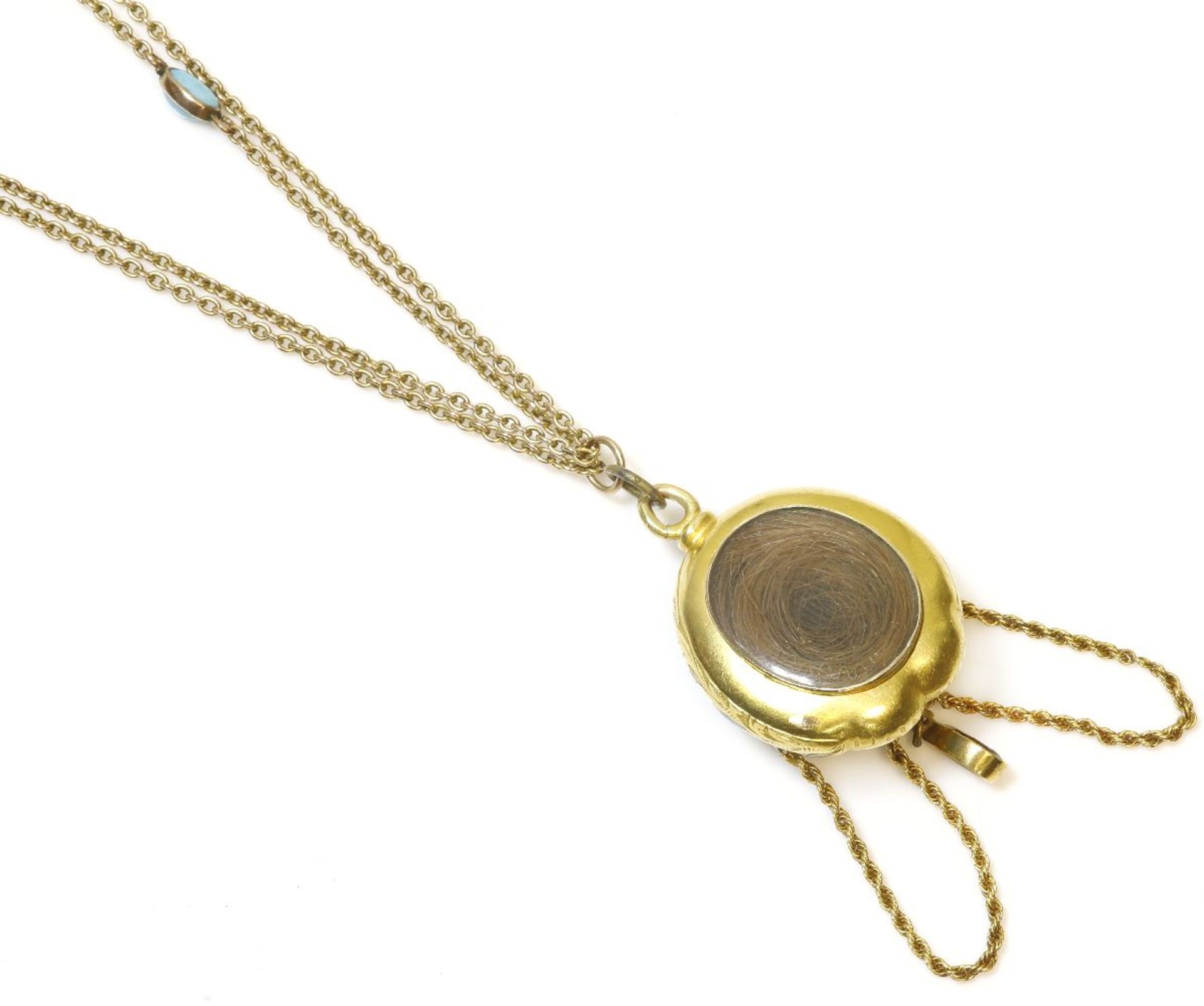 A Victorian gold garnet and blue enamel pendant, a large pear-shaped cabochon garnet, rub set to a - Bild 2 aus 2