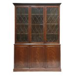 A George III mahogany bookcase,the moulded cornice over a dentil frieze and three astragal glazed