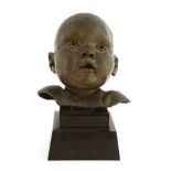 *Sir Jacob Epstein (1880-1959),a cheerful baby's head, bronze, on a stepped black marble plinth,