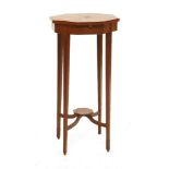 An Edwardian satinwood occasional table,the segmented, crossbanded, octagonal top above a candle