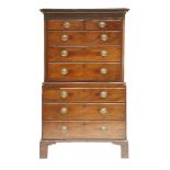 A George III mahogany chest on chest, the top section with a dentil cornice and fluted frieze,