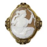 A Victorian gold carved shell cameo brooch depicting Diana,holding a bow, seated in clouds with