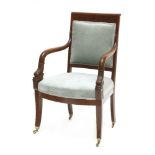 A French mahogany elbow chair,19th century, the padded back over downswept arms with carved