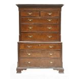 A George III oak chest on chest,with two short and six long drawers within quarter turned reeded