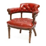 A Victorian oak captain's chair,upholstered in buttoned red leather