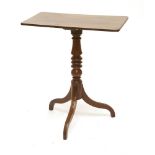 A Regency mahogany tripod table,the rectangular top with a reeded edge on a turned column and