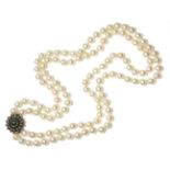 A two row uniform cultured pearl necklace with an emerald cabochon and diamond floral cluster clasp,