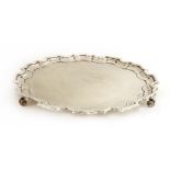 A silver salver,by Walker & Hall, Sheffield 1933, of shaped circular form with a moulded scrolled