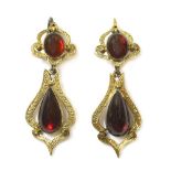 A pair of Victorian gold two stone garnet drop earrings,each earring with an oval cabochon garnet,