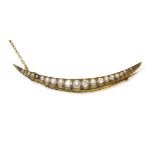 A gold diamond and split pearl open crescent brooch, c.1900, a line of graduated split pearls