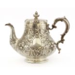 A Victorian silver teapot,by Robert Hennell (II), London 1858, of squat baluster form, embossed with
