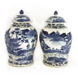 A pair of Chinese blue and white baluster vases and covers,19th/20th century, painted with river