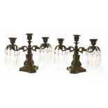 A pair of bronze three-light candelabra,with prismatic drops on triform bases,25cm high (2)