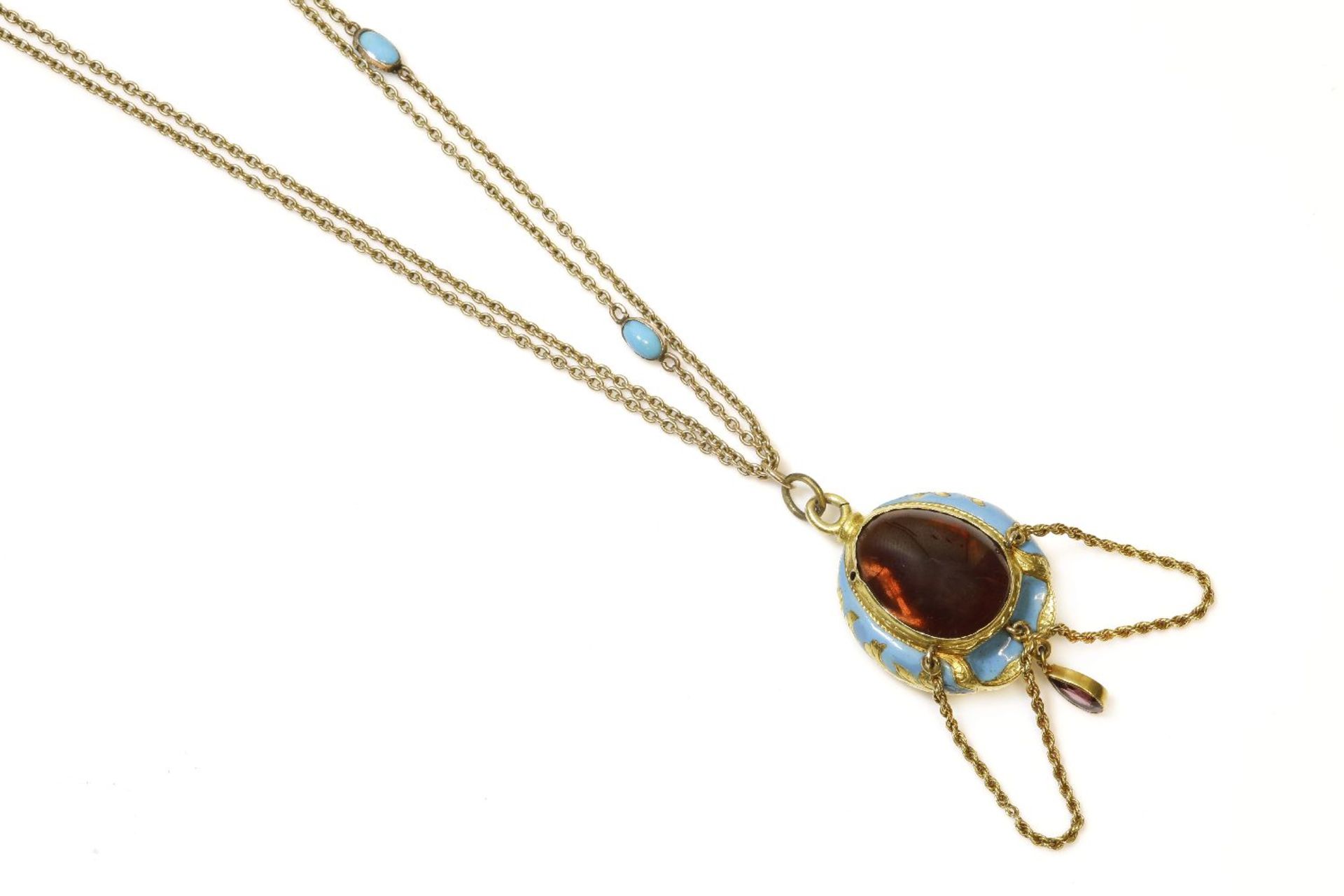 A Victorian gold garnet and blue enamel pendant, a large pear-shaped cabochon garnet, rub set to a