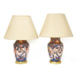 A pair of table lamps,in the form of ovoid vases with Imari-style decoration on turned giltwood