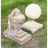 A carved stone urn,on a rectangular plinth,45cm high, anda composition ball finial,on a square