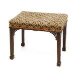 A Chippendale-style mahogany footstool,with a needlepoint seat, over carved square legs and pieced