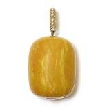 A late Victorian amber and split pearl pendant,composed of a single barrel-shaped egg yolk-