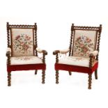 A pair of Victorian mahogany elbow chairs,with twist turned supports and embroidered backs and