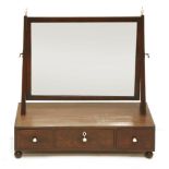 A George III mahogany and crossbanded toilet mirror,the rectangular mirror plate over a three-drawer