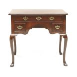 A George II mahogany lowboy,the crossbanded top with re-entrant corners, over three frieze drawers