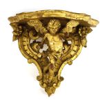 A carved giltwood wall bracket, 39cm high, anda pair of modern gilt wall brackets,32cm high (3)