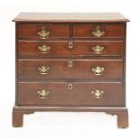 A George III mahogany chest, of two short and three long drawers, with later handles and bracket